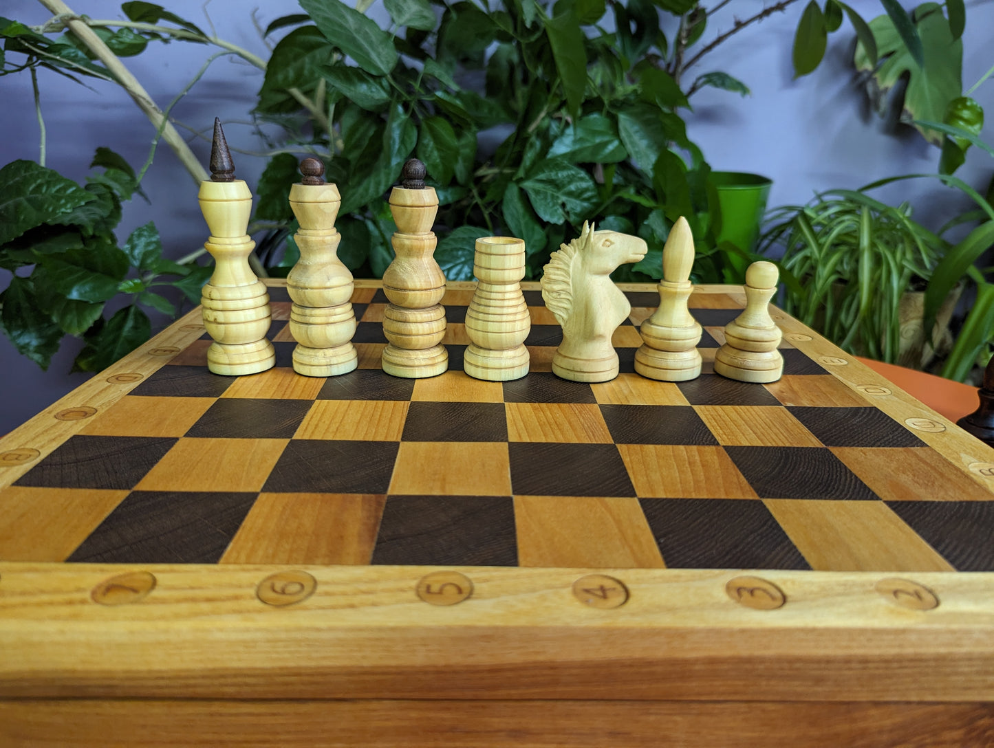 Handcrafted Chess Chest with wooden carved chess pieces inside and with chessboard on top.