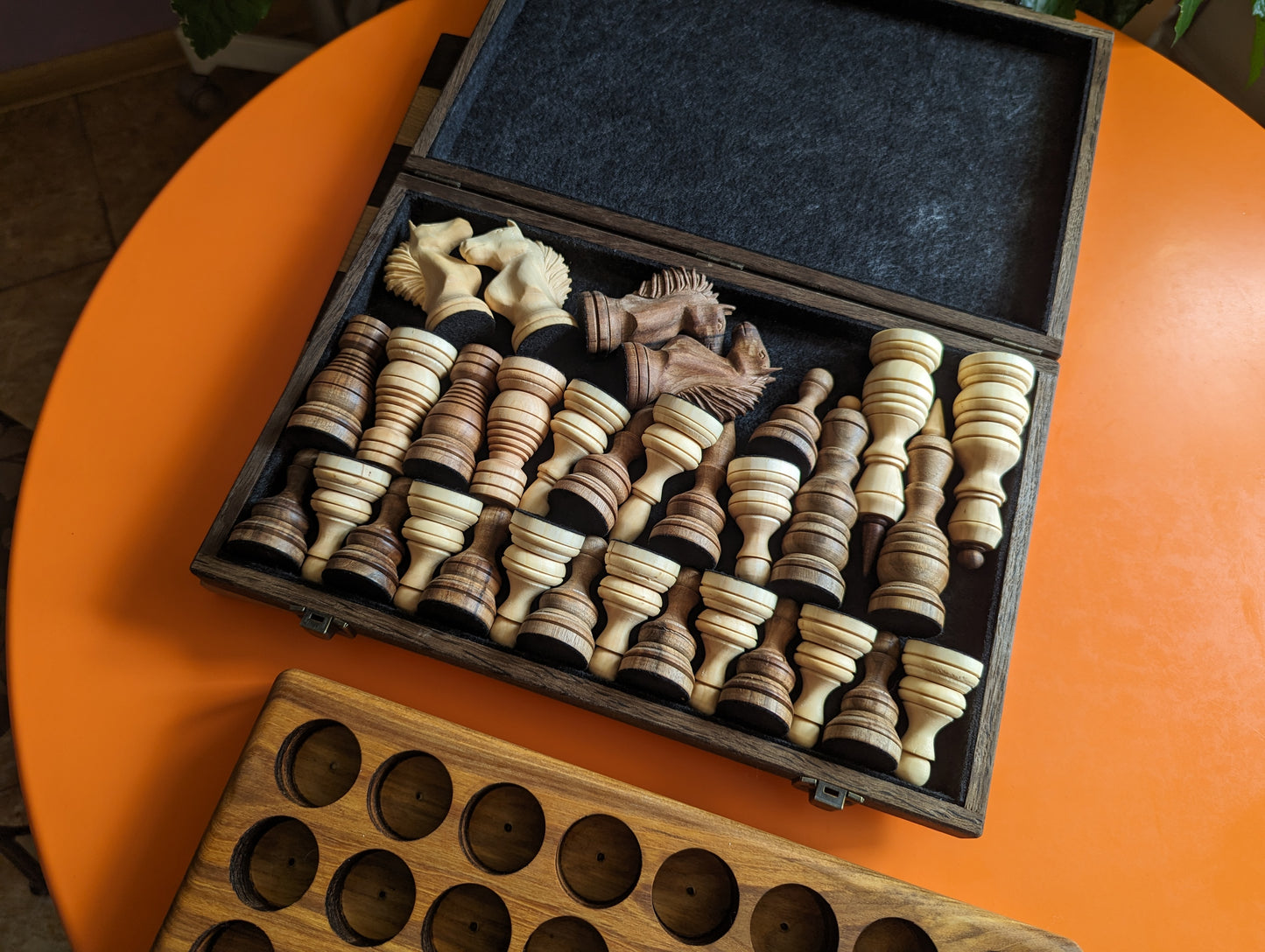 Handcrafted wooden carved chess pieces. White maple and walnut wood.