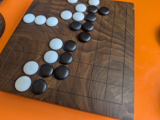 Dark 9x9 Goban with an unusual natural wood texture. Four Seas. Hand carved game Go board