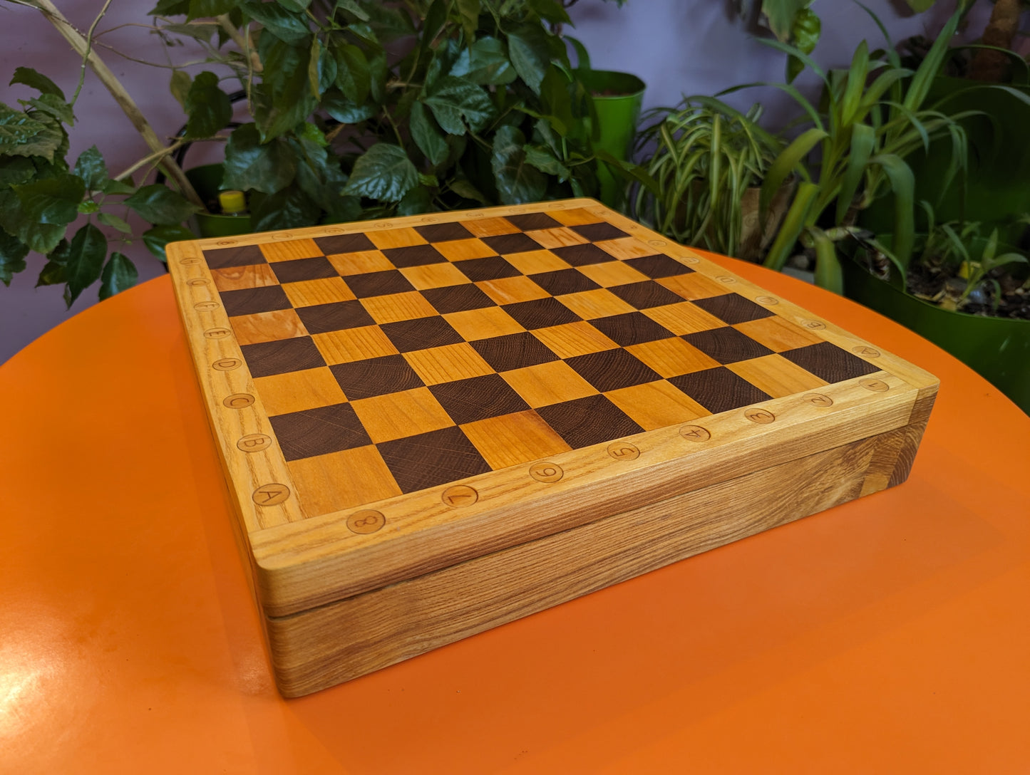 Handcrafted Chess Chest with wooden carved chess pieces inside and with chessboard on top.